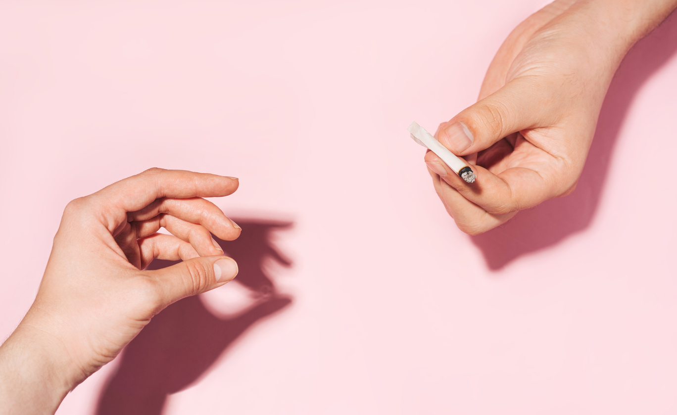 Hand Passing Cannabis Joint